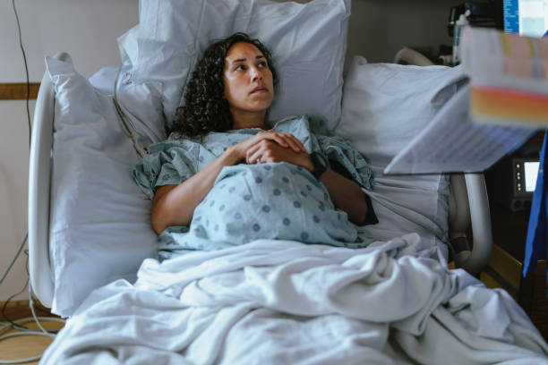 Pregnant woman in labor at the hospital speaking with a doctor stock photo