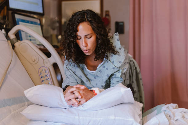 Pregnant woman doing breathing exercises during labor at the hospital stock photo