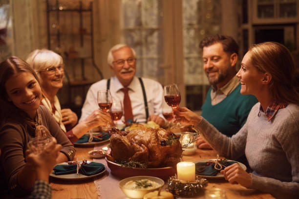 istock Happy extended family toasting during Thanksgiving dinner in dining room. 1434552060