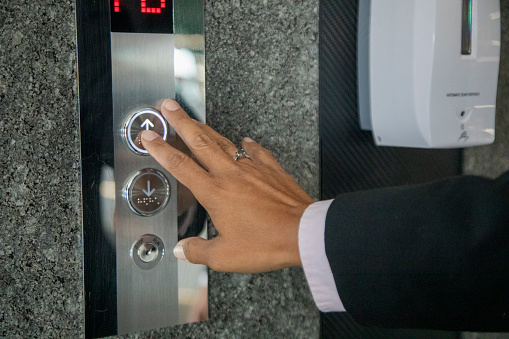 pressing the elevator button