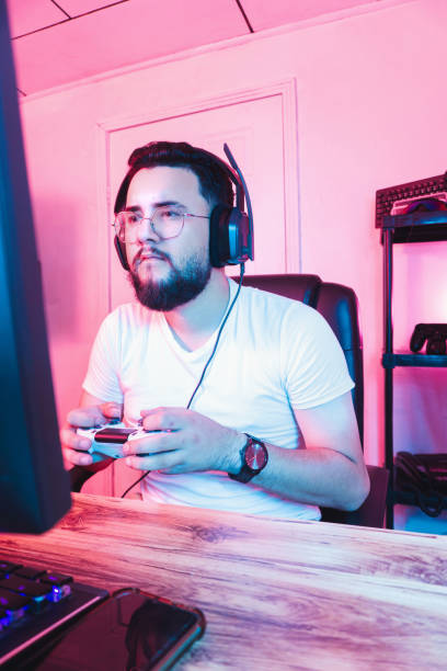 Professional video game player holding a joystick playing with a console.