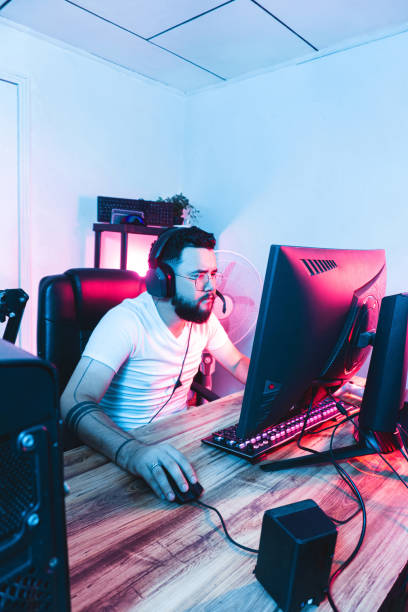 Professional hispanic gamer with headphones playing a online game.