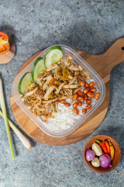 istock rice bowl with spicy chicken and fried peanuts with cucumber 1434571346