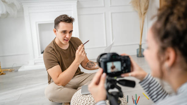 istock artist couple making video blog or course record instruction on camera 1434572728