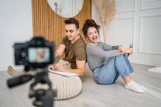istock artist couple making video blog or course record instruction on camera 1434573233