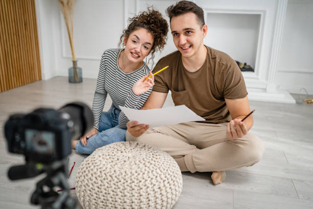 istock artist couple making video blog or course record instruction on camera 1434573350