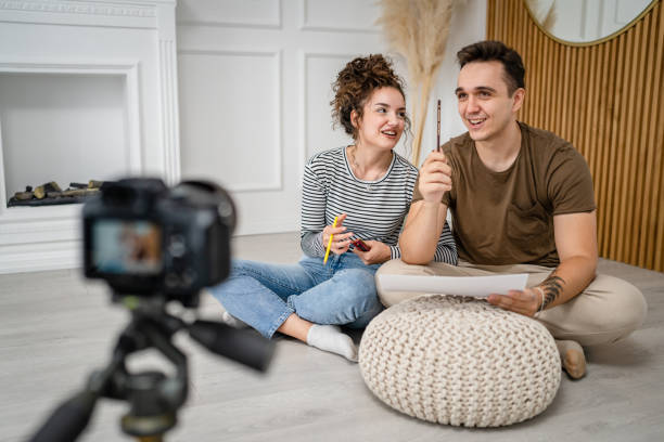 istock artist couple making video blog or course record instruction on camera 1434573351