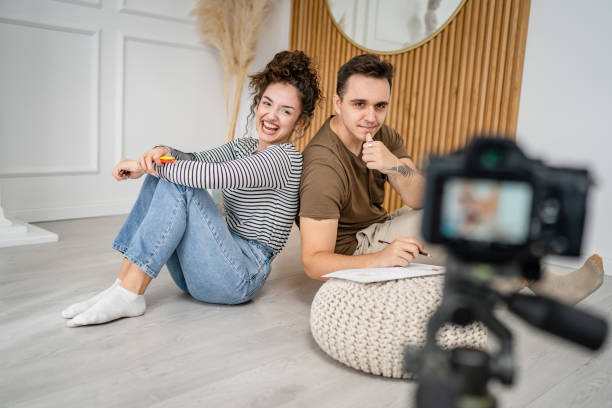 istock artist couple making video blog or course record instruction on camera 1434573895