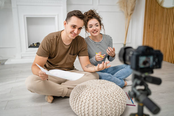 istock artist couple making video blog or course record instruction on camera 1434573897