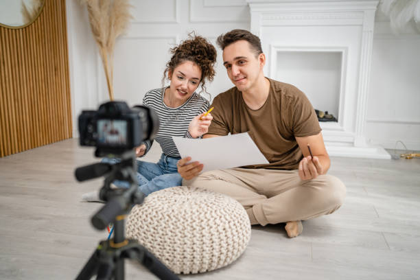 istock artist couple making video blog or course record instruction on camera 1434574475