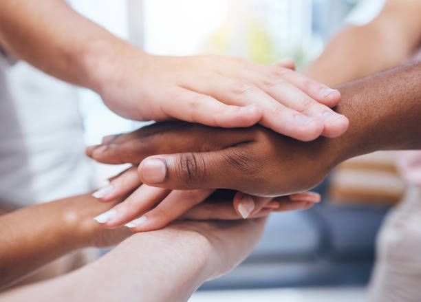 istock Hands, teamwork and support with a team of people working together in collaboration and standing in a huddle. Community, trust and hope with a diverse group joining together in unity and solidarity 1434577735