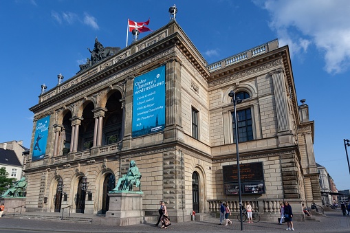 Copenhagen, Denmark – June 08, 2013: The Royal Theatre facade in Copenhagen, Denmark against a clear blue sky