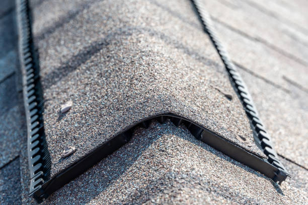 istock Ridge cap vent installed on a shingle roof for passive attic ventilation on a residential house. 1434584858