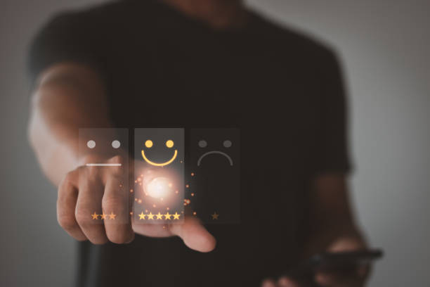 istock Customer service and satisfaction. Businessman touch on the virtual screen to select the smiley face icon for client evaluation and customer satisfaction after using the product and service concept. 1434586424