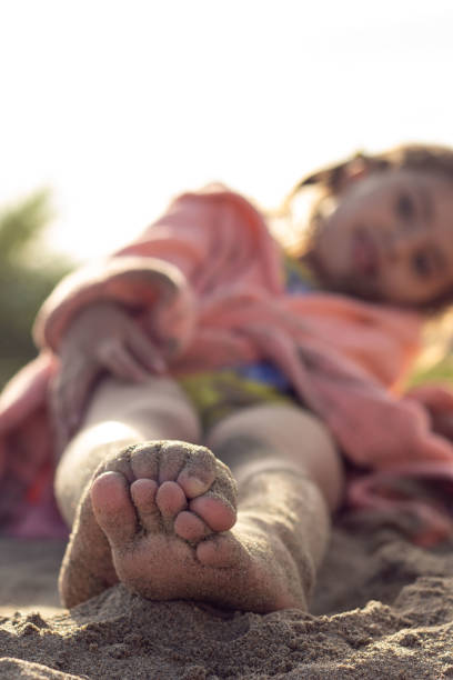 istock Cute girl laying on the beach 1434587232