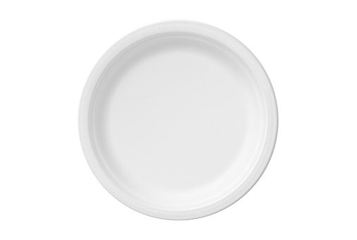 Round disposable polystyrene foam (Styrofoam) plate, isolated on white background.