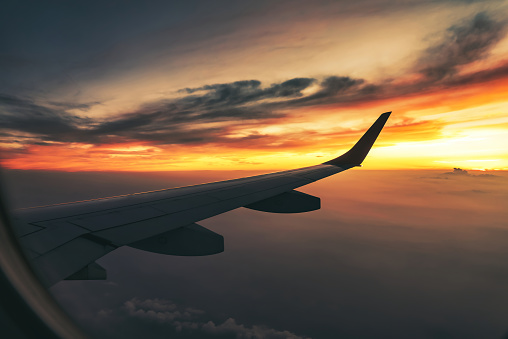 The airliner flies at sunset