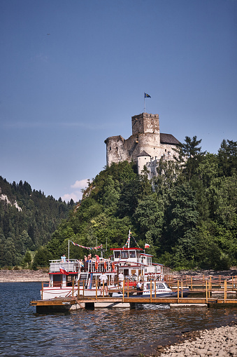 Czorsztyn, Poland - July 05, 2015 : Niedzica Castle and a boat on the hill in Pieniny Mountains