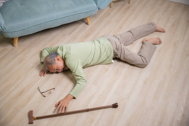 istock Sick senior old man falling down lying on floor because stumbled at home 1434595008