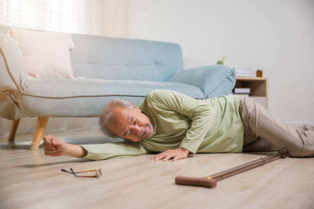 istock Asian old man lying on floor after falling down with wooden walking stick 1434595033