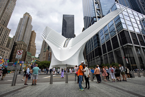 June 18,2022: Crowd of people in the street outside of the Oculus, World Trade Center Transportation Hub, Lower Manhattan of New York City, USA. The Oculus Hub was designed by architect Santiago Calatrava.