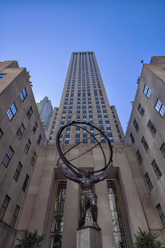 Low angle view of the Atlas Statue in front of the Rockefeller Center in midtown Manhattan New York City.