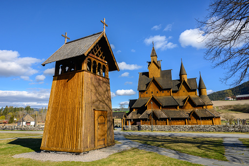 Heddal Stave Church and its wooden belfry lit by the morning sun in late April. Heddal Stave Church, constructed at the beginning of the 13th century, is Norway's largest stave church.