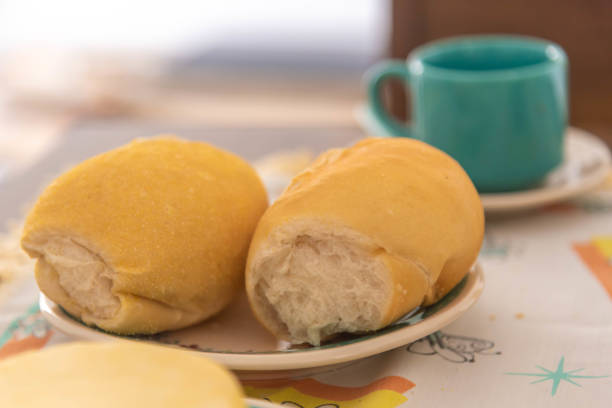 Table with coffee, bread, cheese and cake with nuts.