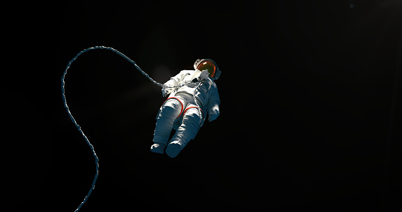 Hovering spaceman on a black background with a copy space for a astroscience topics and designs.3D rendered cosmonaut in a white spacesuit on a black background. Asronaut on a black background levitating in an outer space. Astronaut in a space