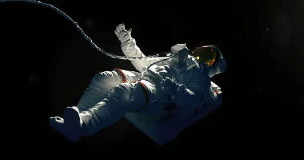 Spaceman on a black background hovering in an outer space. Astronaut in a space