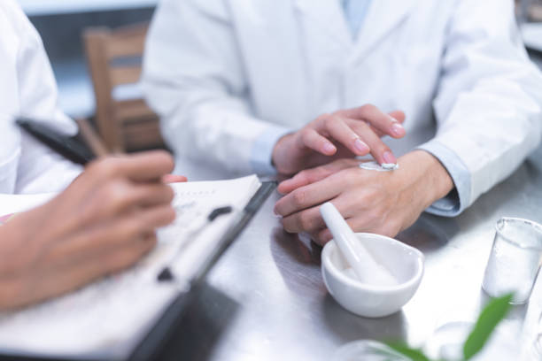 istock Beauty eco cosmetic research and development concept, Scientist or Pharmacist applying moisturizer lotion on her hand for efficacy testing of natural organic skincare products in laboratory 1434607458
