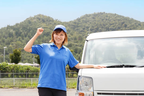 istock Female mover and truck driver. She is in a victory pose. 1434607635