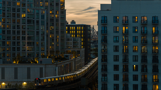 An elevated subway train riding on the line in Long Island City, Queens.