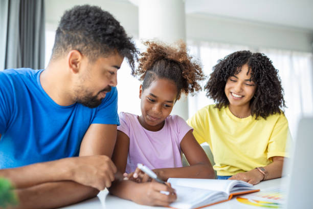 istock A mixed race husband and wife doing homework with their daughter while social distancing and isolating at home during the Covid-19 pandemic. 1434612310