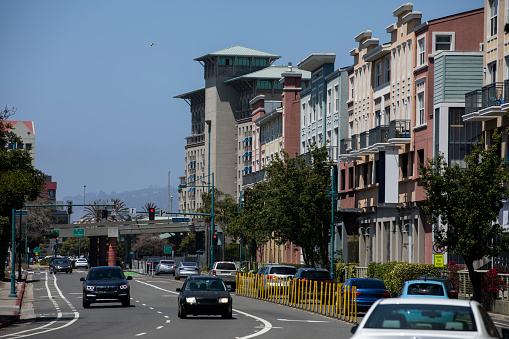 Daytime view of traffic passing through downtown Emeryville, California, USA.