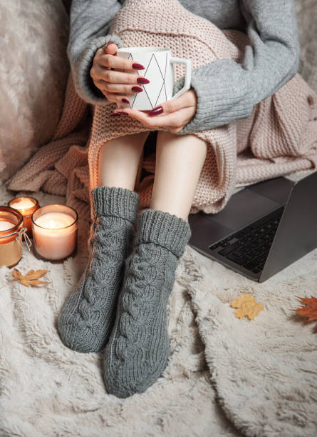 istock Cozy home, woman covered with warm blanket, drinks coffee. 1434614582