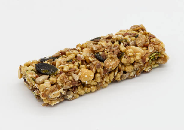 Protein bar with whole grains peanuts and cranberries isolated on white background. stock photo