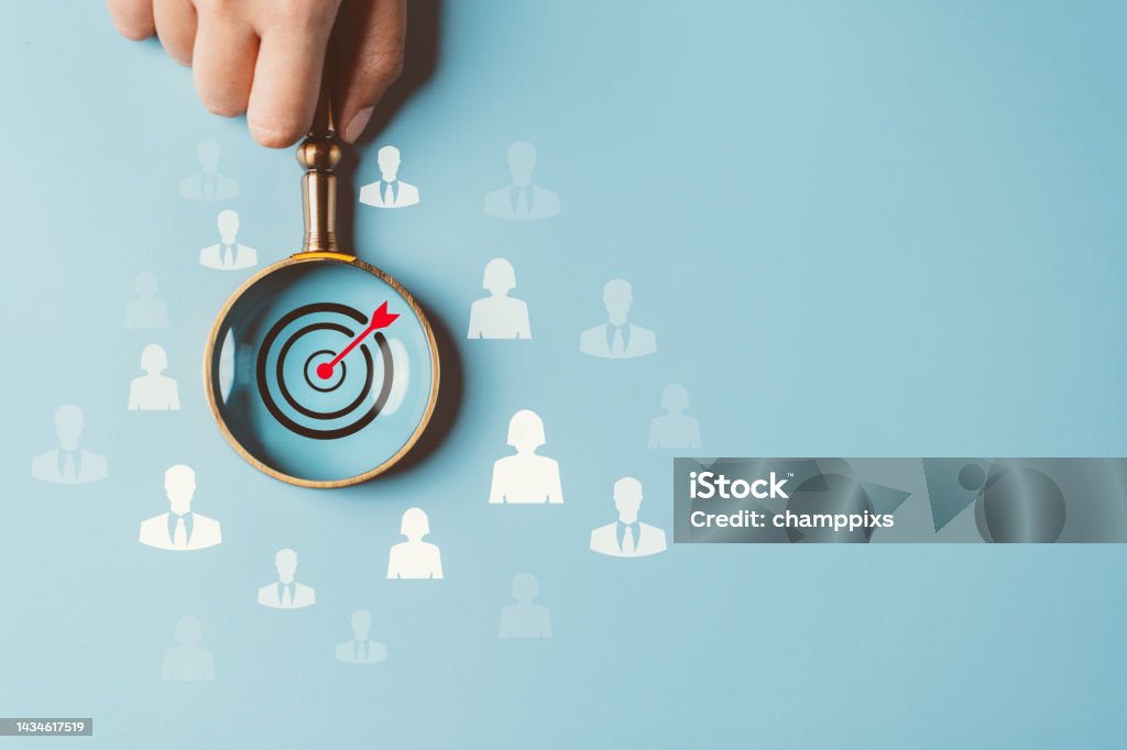 HRM or Human Resource Management, Magnifier glass focus to manager business icon which is among staff icons for human development recruitment leadership and customer target group concept. Recruitment Stock Photo