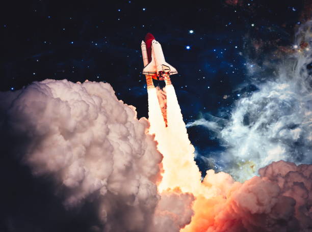 istock shuttle launch in the clouds to outer space. Dark space with stars on background.Spaceship flight. Elements of this image furnished by NASA 1434618521