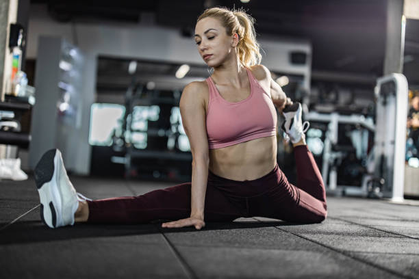 istock Athletic woman stretching her legs in a gym. 1434619214