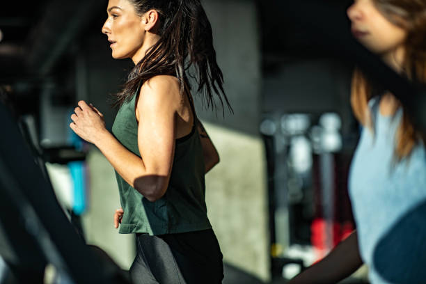 istock Determined athletic woman running on treadmill in a gym. 1434620194