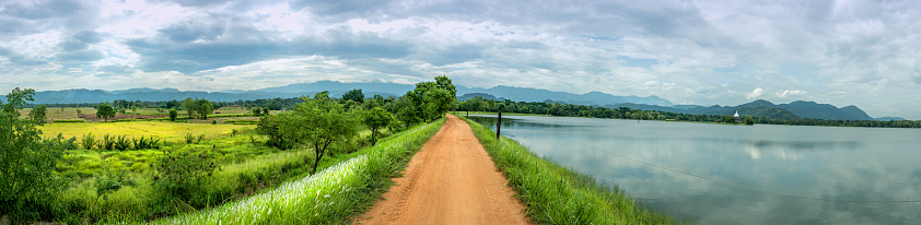 Beautiful village road in kandiyapita wewa village, Hambegamuwa, Sri Lanka. Created this panorama with 4 shots.