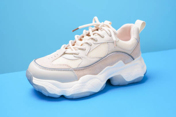 istock Trendy sneaker on a blue background close-up side view. 1434624063