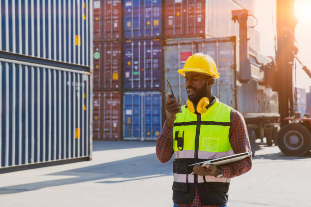 istock customs shipping staff worker working at cargo port container ship yard with radio control 1434627654