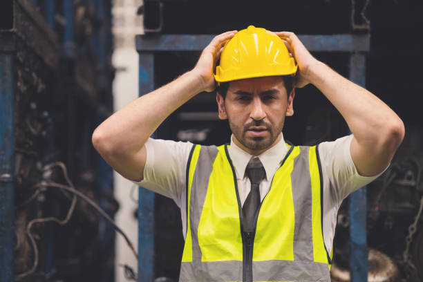 istock engineer worker male hand holding his head for headache shocked the problems in factory 1434627694