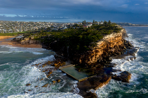 Aerial landscape views of North Curl Curl  headland and rock pool iand beach in Sydney's Northern Beaches Ausralia