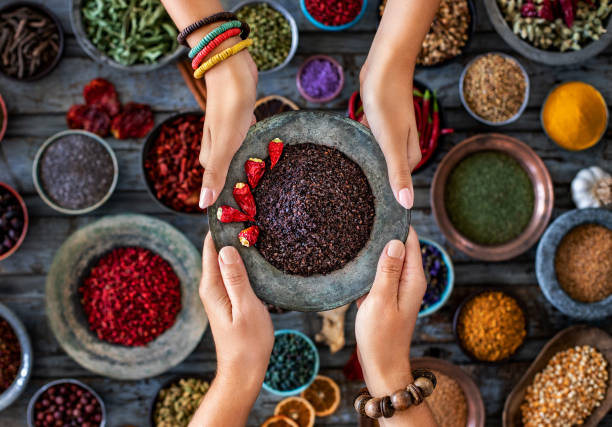 Various spices and dried fruits at the hands of two women. isot and sumak Background concept with spices. sumac spice stock pictures, royalty-free photos & images