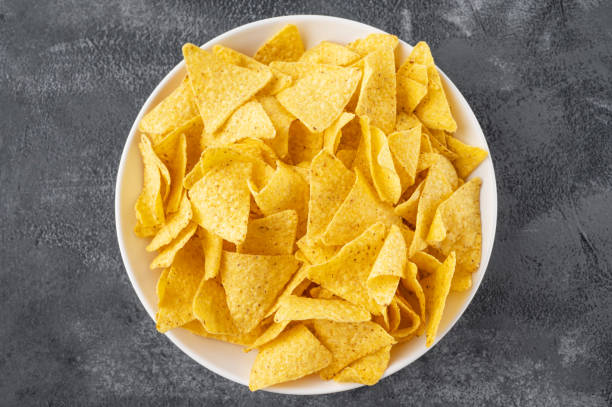 istock Mexican Nachos chips and dip sauces. Tortilla corn nachos chips with tomatoes salsa and guacamole. Top view. 1434629177