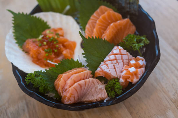 fresh sliced salmon or salmon sashimi with salmon ikura or salmon egg in bowl set on table. - buffet japanese cuisine lifestyles ready to eat imagens e fotografias de stock