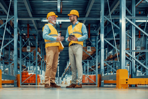 istock Managers in warehouse discuss about business 1434630648